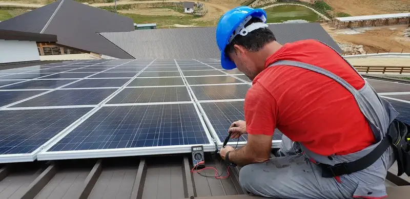 A technician installing solar panels.